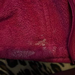 it has a paint stain that could possibly come out no zipper, which can be fixed